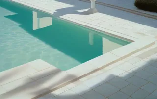 A luxury Temecula backyard pool with a resurfaced stamped concrete deck, designed for both elegance and safety.